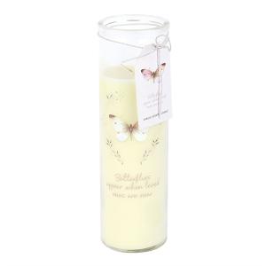 Cream-colored pillar candle in a glass jar with a butterfly motif and decorative tag.