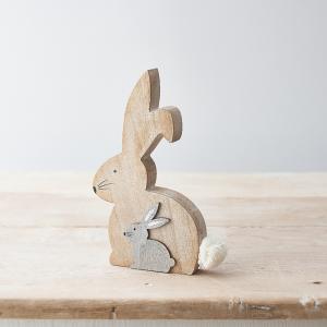 Wooden bunny figurine with a smaller gray bunny cutout and a white fluffy tail.