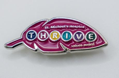 Pink leaf-shaped enamel pin for St. Michael's Hospital THRIVE volunteers.