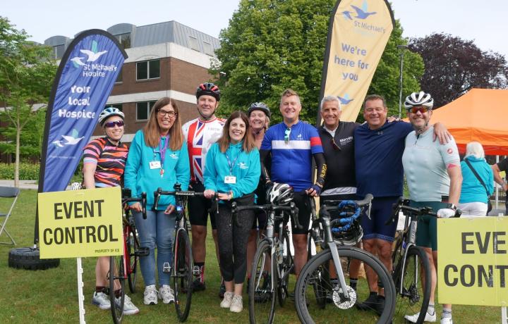 Group of cyclists standing by their bikes having completed the challenge