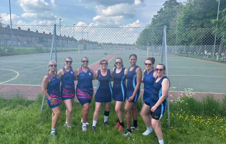 netball team standing outside of a netball court
