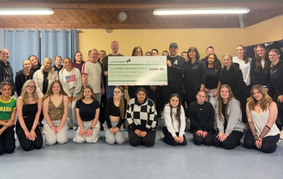 Members of the Happy Feet Dance Academy presenting a cheque