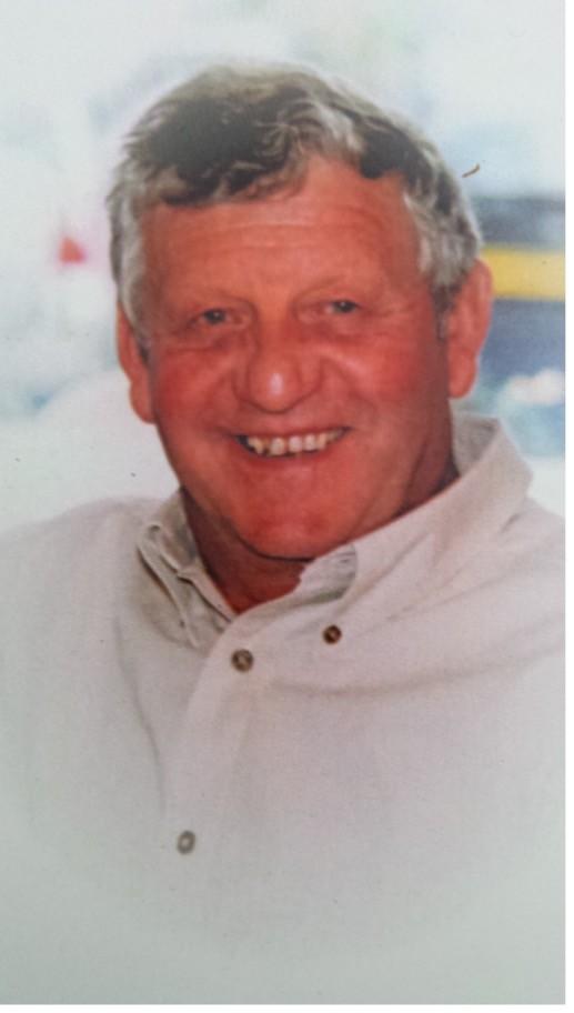 Chris: Smiling older man with gray hair in a light shirt.