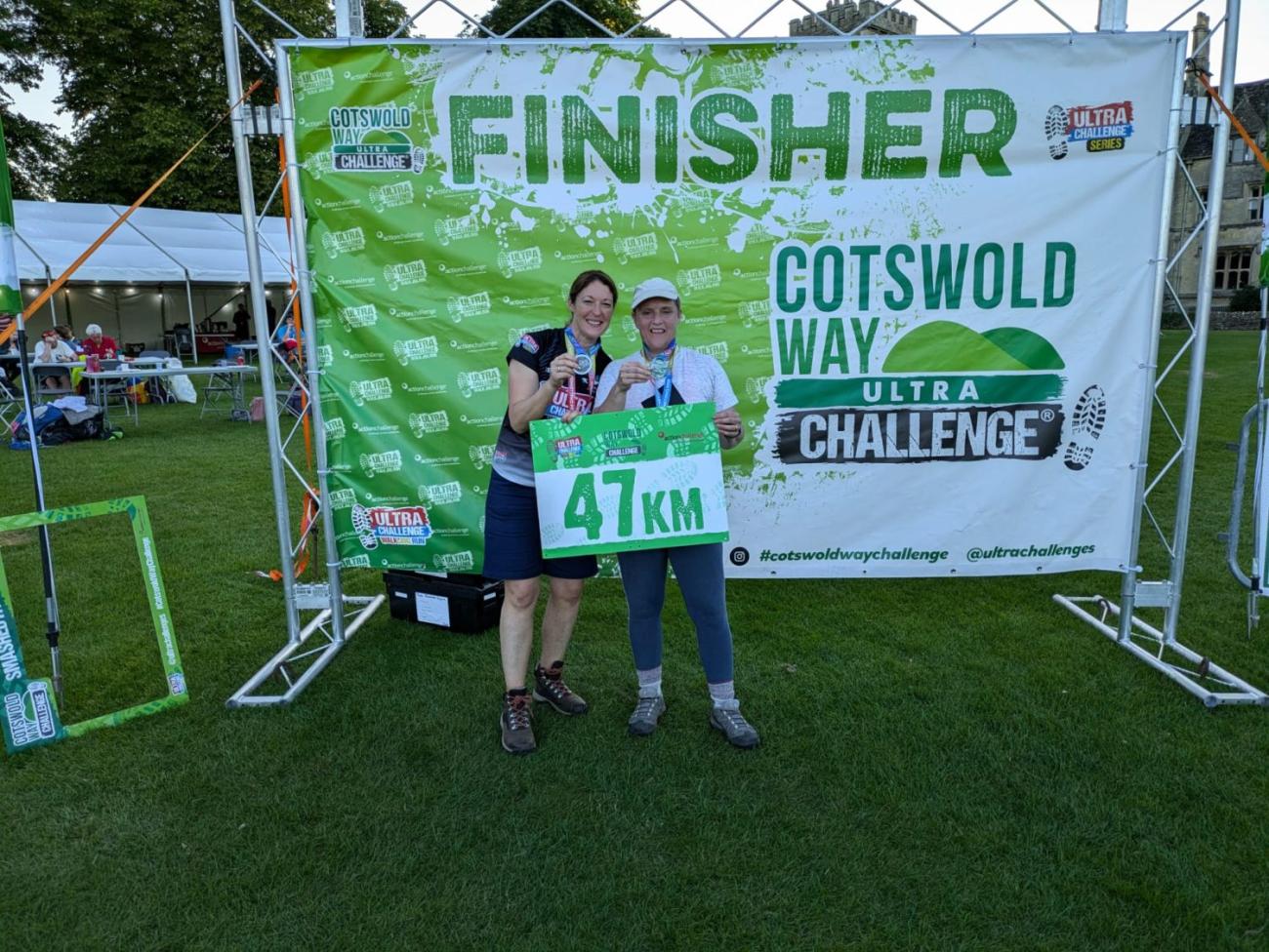 two runners posing infront of Cotswold Way Ultra Challenge finish